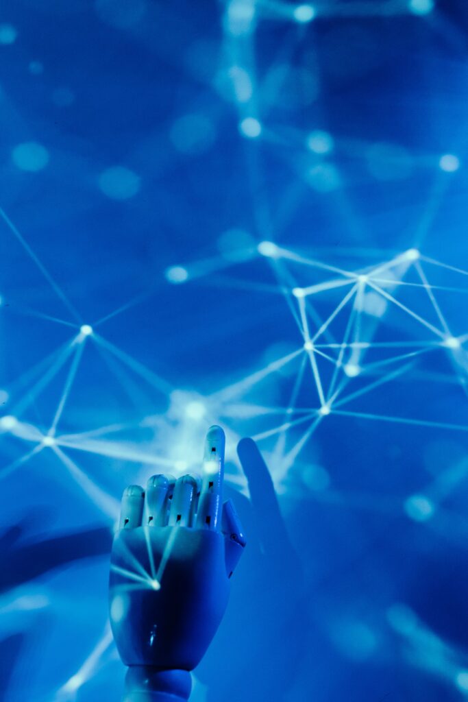 Cybersecurite 2026 : l’IA, arme des deux camps Futuristic robotic hand touching a digital network on a blue background.