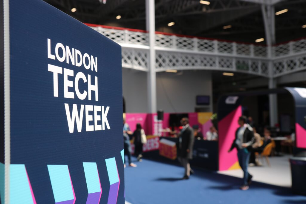 Computex, WWDC, VivaTech : juin 2026, le mois qui fait trembler la tech Vibrant indoor scene at London Tech Week with attendees and colorful displays.